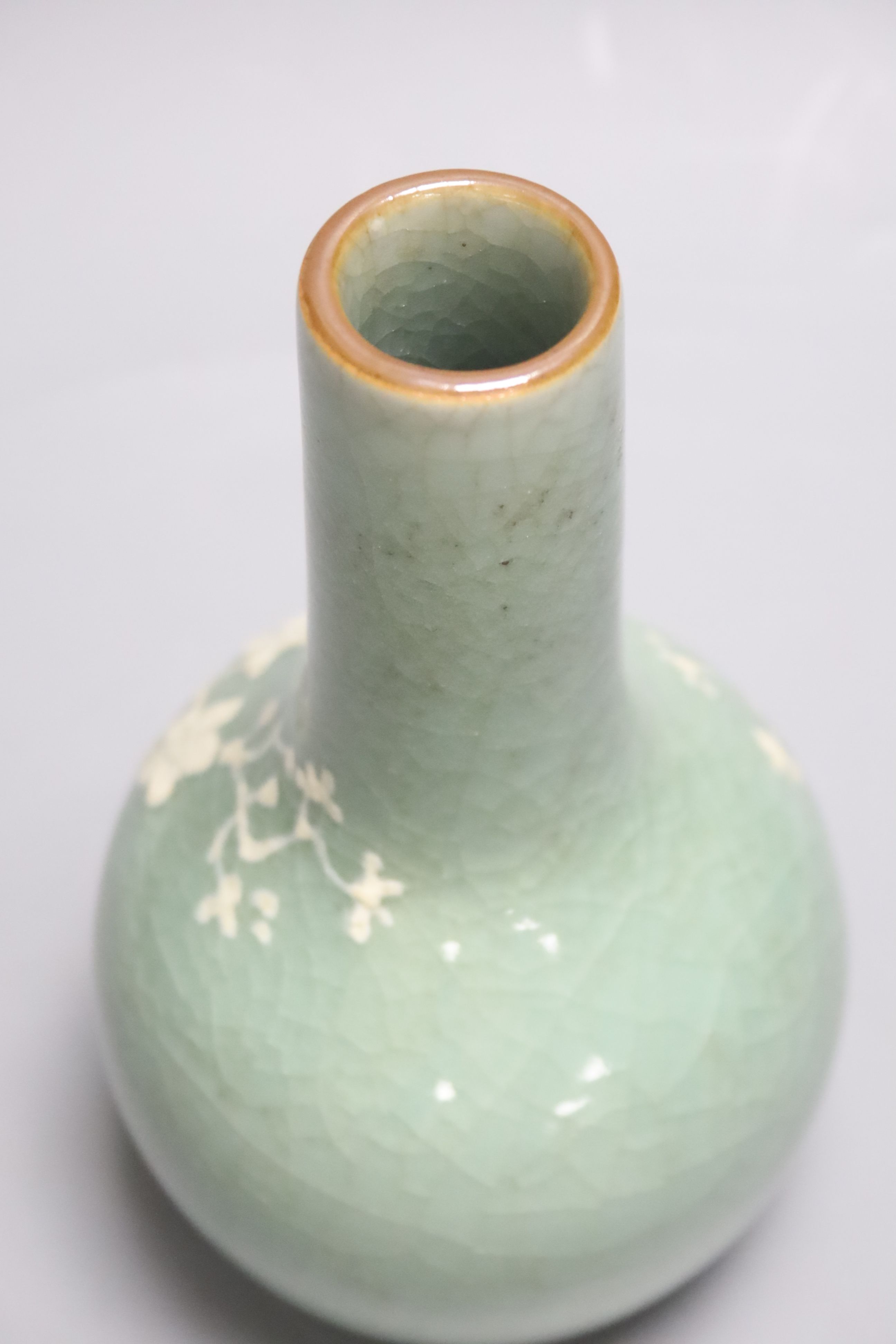 A Chinese celadon bottle vase with white slip decoration, 19th/20th century, height 20cm